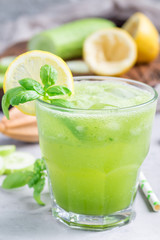 Healthy lemonade with cucumber, basil, lemon, honey and sparkling water, vertical