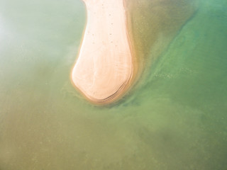 Top view of the sand near the waves of sea