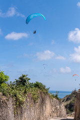 Fototapeta na wymiar Raraplane flying in the beautiful sky. Tropical Bali island, Indonesia. Extreme sport.