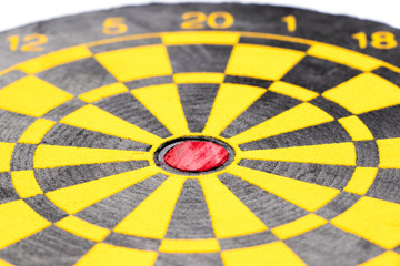 Yellow and black color dart board with number on white background (Focus at red point)