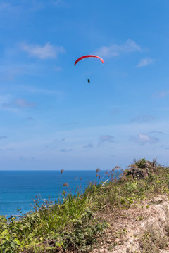 Raraplane flying in the beautiful sky. Tropical Bali island, Indonesia. Extreme sport.