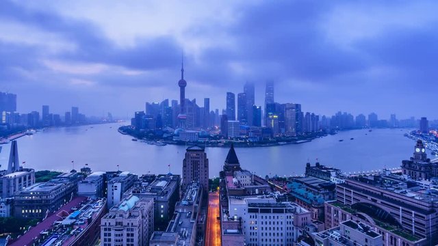 4K Zoom Out: China Shanghai at Dawn.Aerial view of high-rise buildings with Huangpu River in Shanghai bund, China.