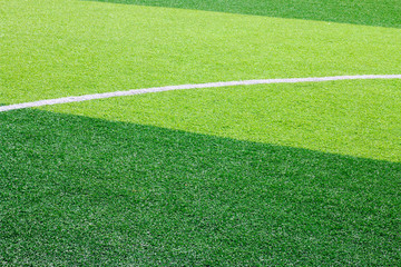 Photo of a green synthetic grass sports field with white line shot from above