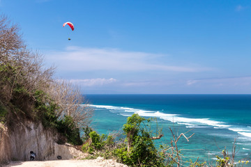 Raraplane flying in the beautiful sky. Tropical Bali island, Indonesia. Extreme sport.