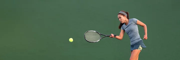 Fototapeten Tennis player Asian woman playing hitting ball on court banner. Copy space panorama crop on green background. © Maridav
