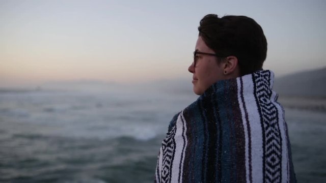 Portrait Of Happy Road Tripper Looking Out At Ocean View At Sunset