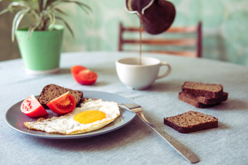 Breakfast fried egg and tomatoes.Coffee from cezve