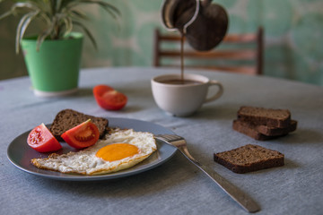 Breakfast fried egg and tomatoes.Coffee from cezve
