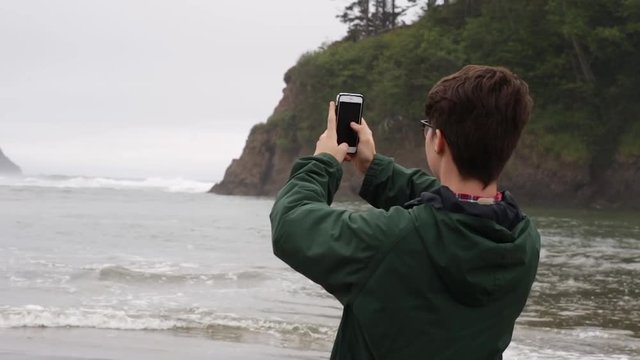 Tourist Takes Smartphone Photos Of Beautiful Oregon Beach On A Foggy Day