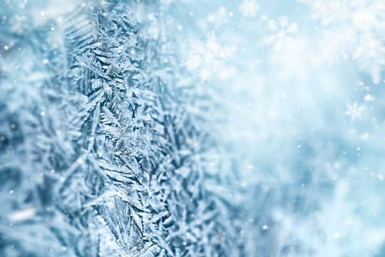 Macro of frost crystal and fallen defocused snowflakes 
