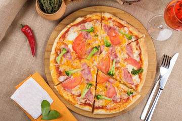 Pizza with ham, tomatoes and cheese. top view.