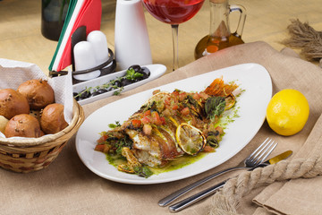 Fried fish with vegetables and lemon sauce.