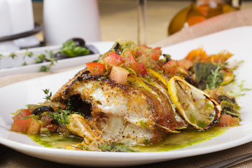 Fried fish with vegetables and lemon sauce.