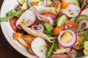 Fresh vegetable salad with pickled mushrooms and sunflower oil. Close up.