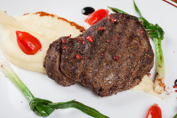 Steak with mashed potatoes.