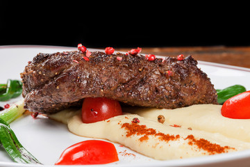 Steak with mashed potatoes.