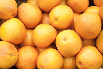 Juicy grapefruits in a big marketplace Grapefruit background