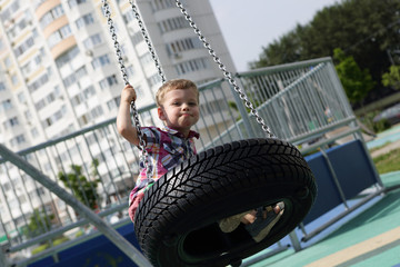 Child on swing out of tire