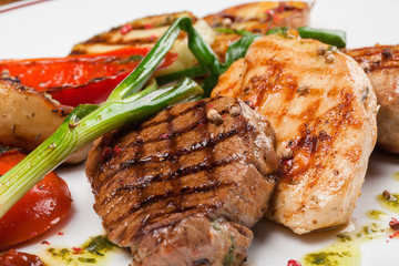 Three steaks from different meat with grilled vegetables