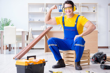 Repairman carpenter working with wooden plank planks