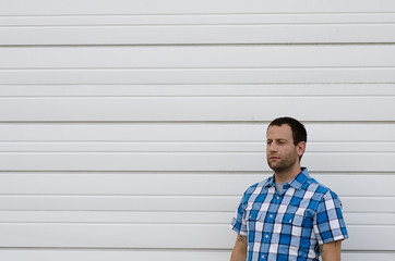 Man looking to the left alone against a white background. 
