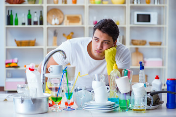 Man frustrated at having to wash dishes