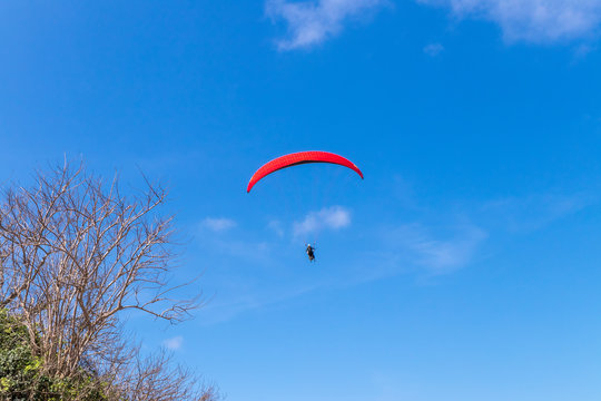 Raraplane flying in the beautiful sky. Tropical Bali island, Indonesia. Extreme sport.