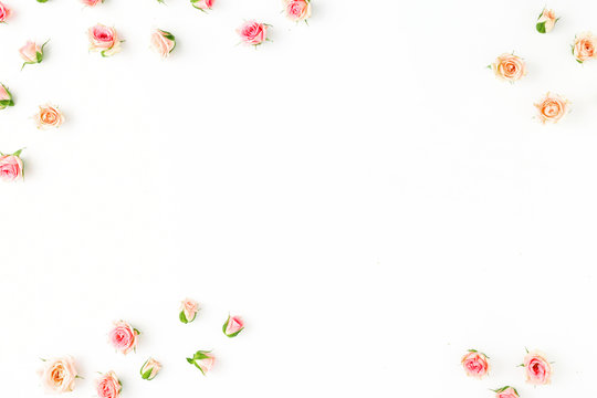 Frame of pink roses on a white background. Flat lay