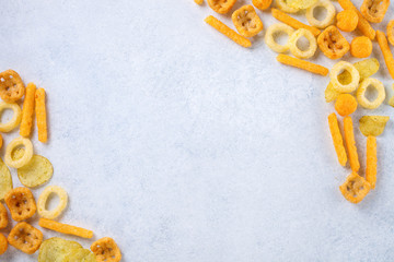Chips, snacks on a light background. Top view. Copy space