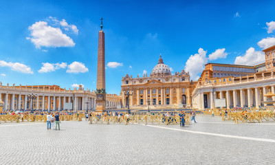 Fototapeta na wymiar St. Peter's Square and St. Peter's Basilica, Vatican City in the day time, tourist around. Italy.