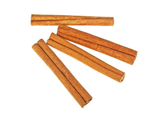 Spices. Four cinnamon sticks on a white background, top view.