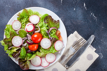 Healthy food - vegetables  salad on a dark background. Selective focus. Copy space. Top view