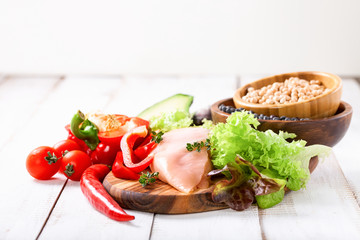 Raw chicken and fresh vegetables on a table. Healthy food. Selective focus. Copy space
