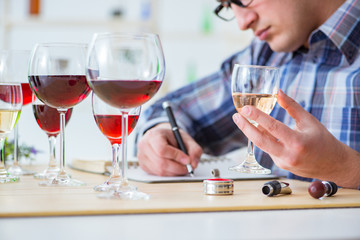 Professional sommelier tasting red wine 