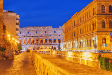 Beautiful landscape of the Colosseum in Rome through street Via degli Annibaldi  in the night time.