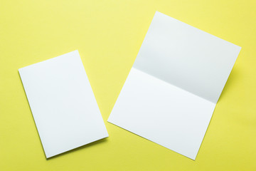 White empty card on yellow background to replace your design. Open and closed.