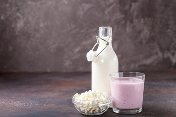 Milk, yogurt and cottage cheese against a dark background. Selective focus. Copy space