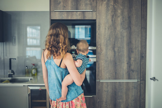 Mother with baby in kitchen