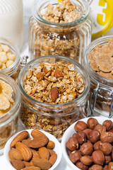 assortment of breakfast cereals and nuts, vertical