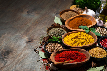 assortment of oriental spices on a wooden background