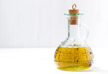 bottle of olive oil on a white table