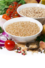 brown rice and quinoa soup and ingredients on a white background, vertical closeup