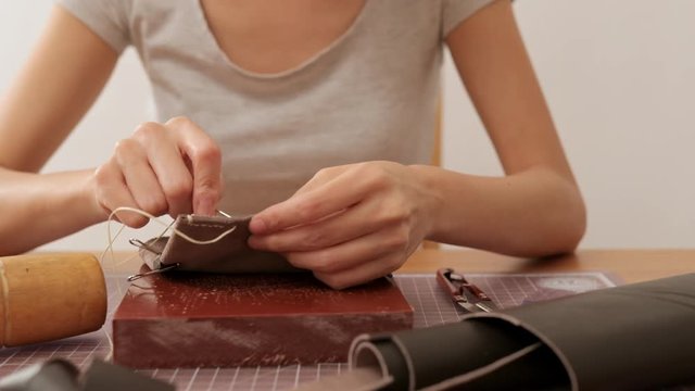 Female craftswoman design a leather bag
