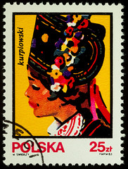 Young woman with Polish traditional hat on postage stamp