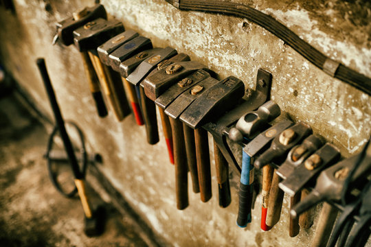 Blackmith tools in worksshop different pliers and hammers