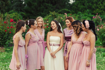 Bride with bridesmaids in pink dresses for a walk