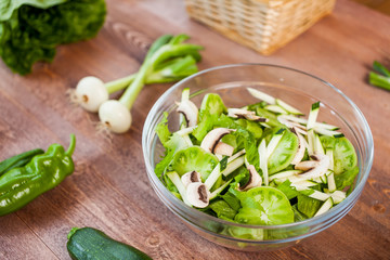 vegetable green salad bowl on kitchen table, balanced diet