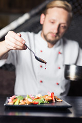 male cooks preparing meals in restaurant kitchen
