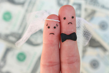 Fingers art of couple on background of money. Concept of wedding, woman and man needs to get...