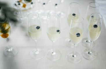 waiter and glasses of champagne on table